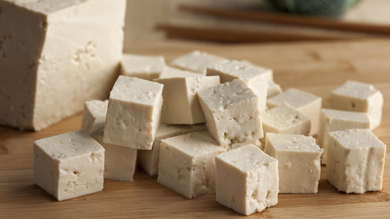 Tofu cubed on a cutting board