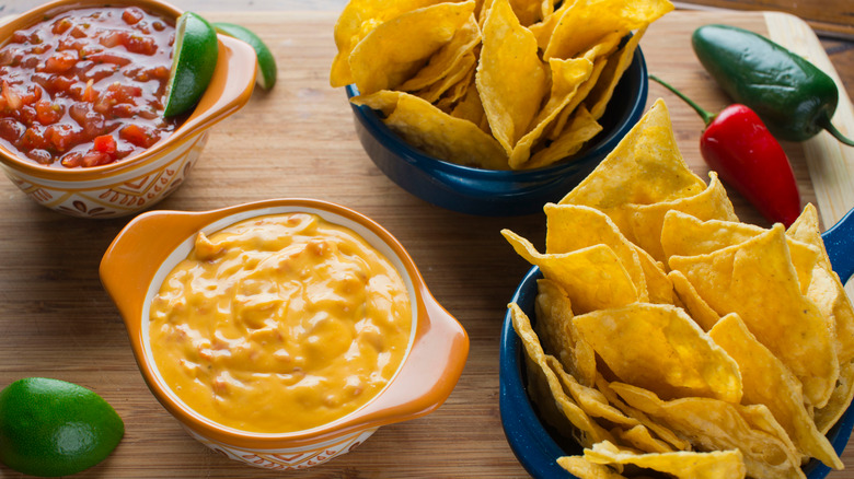 Small bowls of queso and salsa with tortilla chips