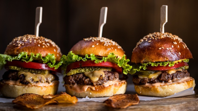 three cheeseburger sliders on a tray