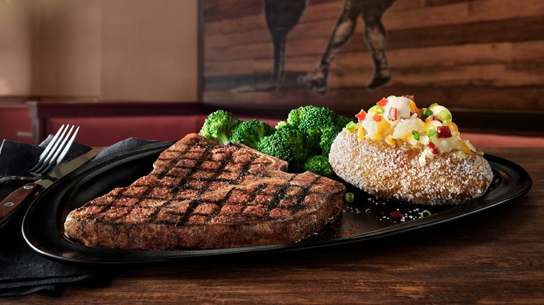 A Melbourne Porterhouse next to broccoli and a baked potato