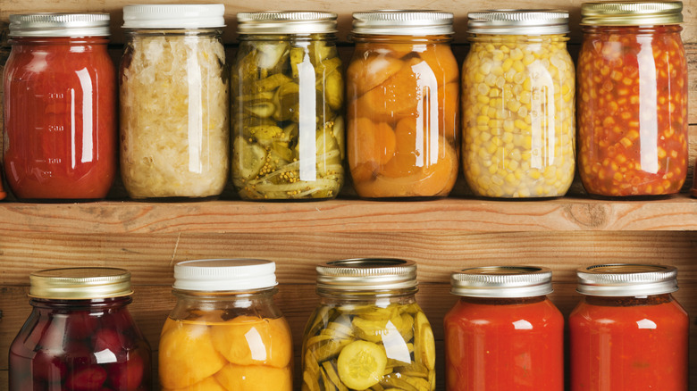 various canned goods on wooden shelves