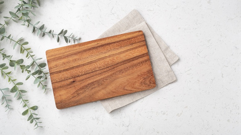 Wooden cutting board with towel