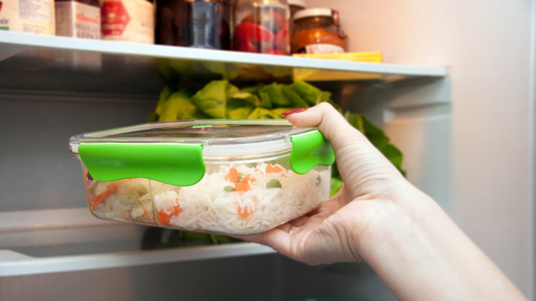 Leftover rice in container in refrigerator 
