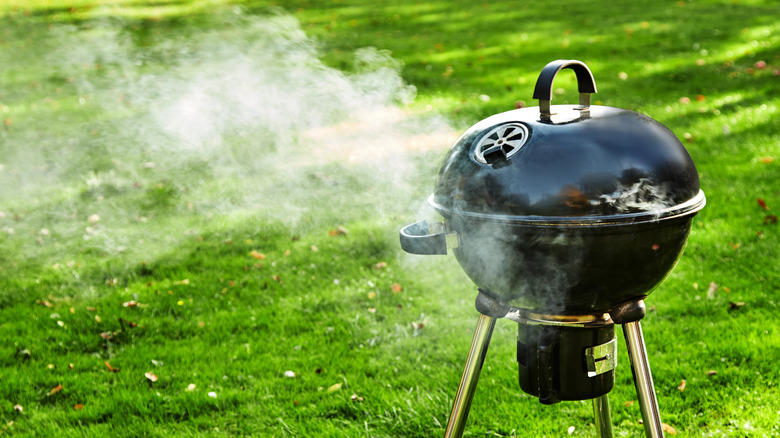 Charcoal grill vents with smoke