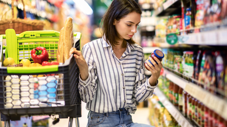 woman checking product in grocery store