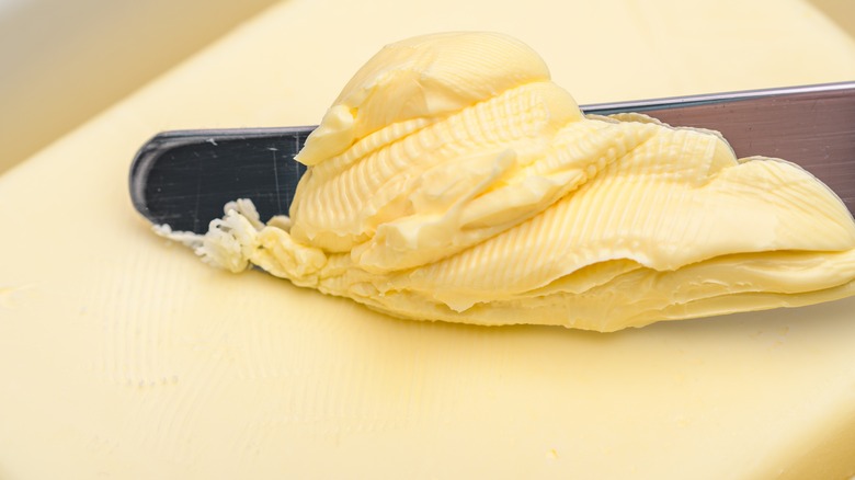 Butter being scooped by a spread knife