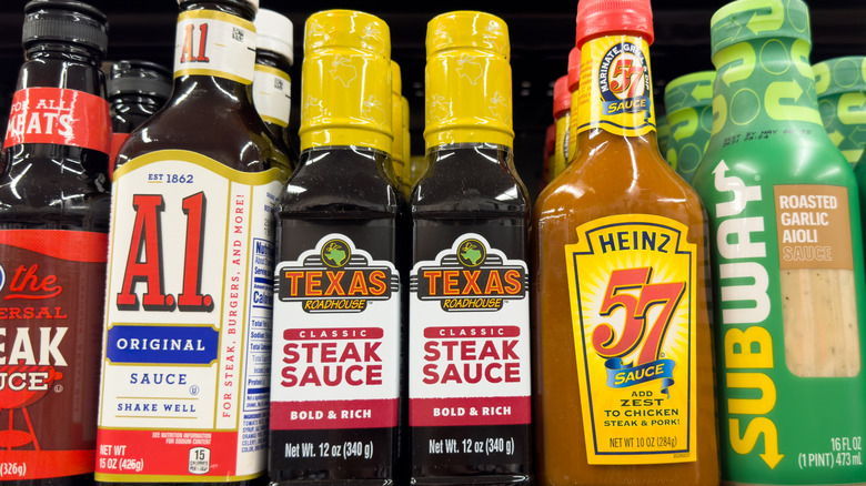 Bottles of steak sauces displayed in a grocery store.