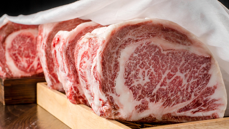 Chunks of wagyu beef on a wooden platter