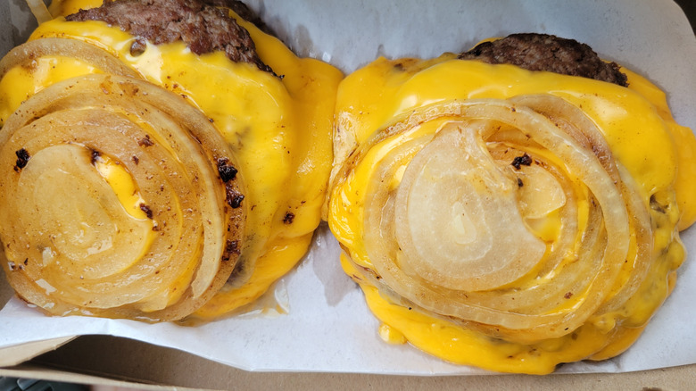 Two In-N-Out Flying Dutchmen, which is a burger patty smothered in cheese and grilled onions with no bun