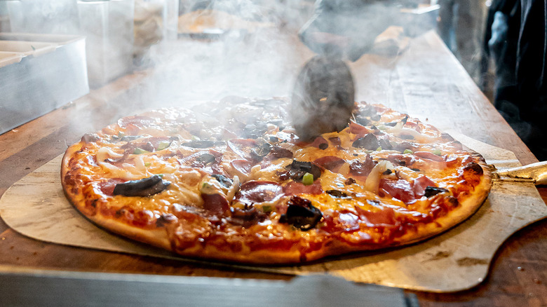 Hot pizza getting sliced at GAPCo in Dallas.