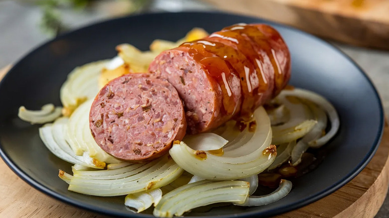 Sliced bratwurst served over onions.