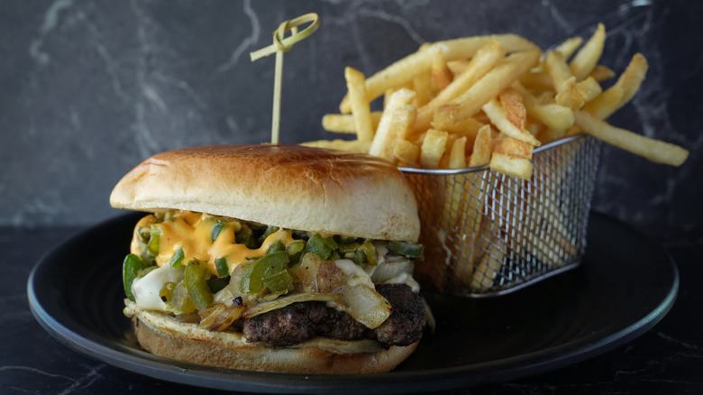 A Hatch Green Chile Cheese burger with fries.