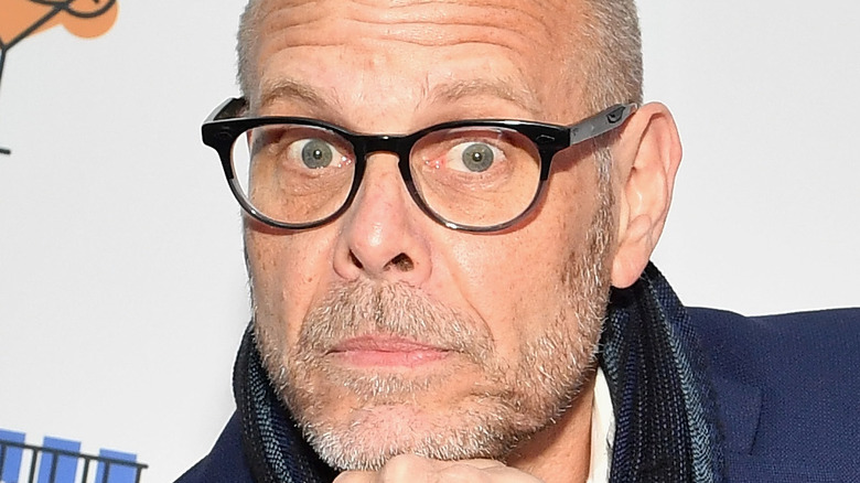 Alton Brown resting chin on fist at Food Network event