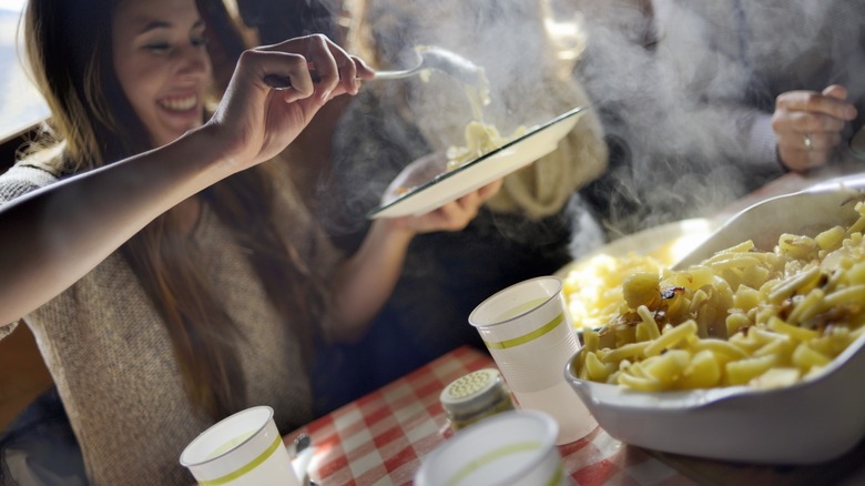 woman serving hot plate of food