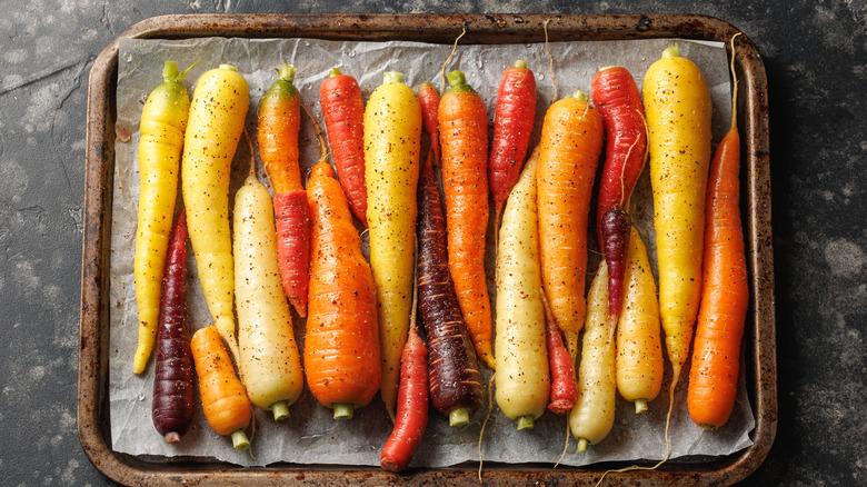 Seasoned colorful carrots on a sheet tray