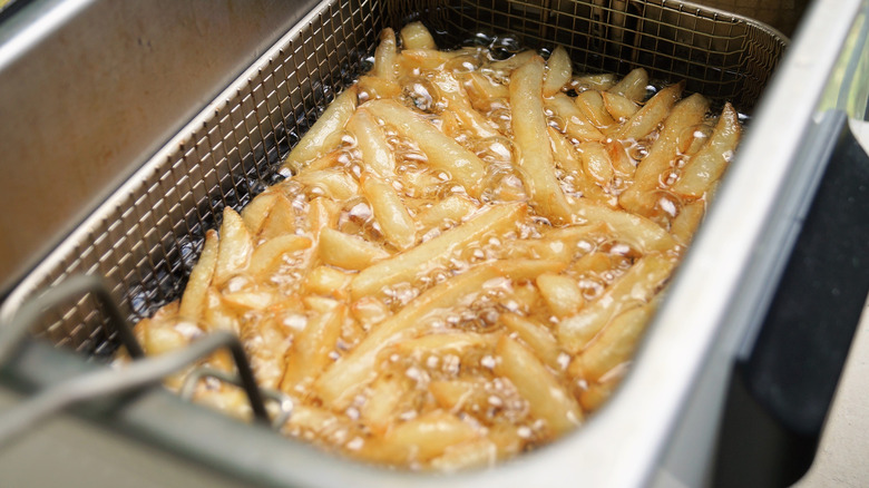 French fries cooking in a fryer