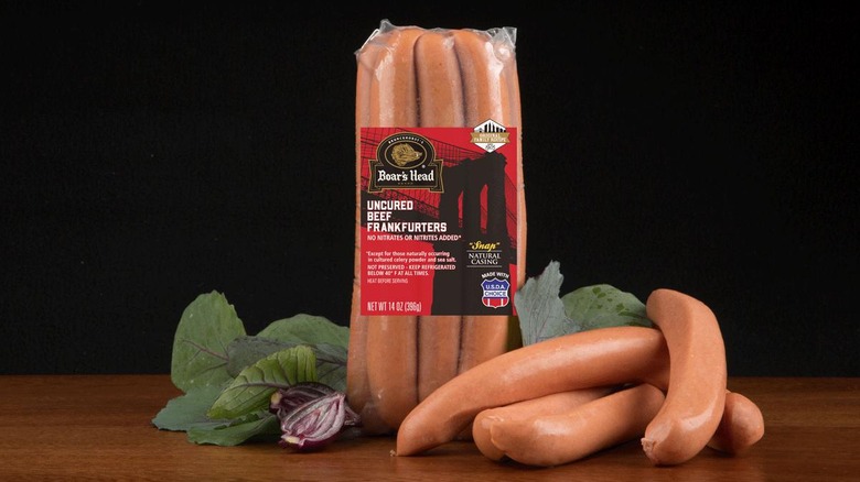Package of Boars Head Beef Frankfurters resting on a wooden counter