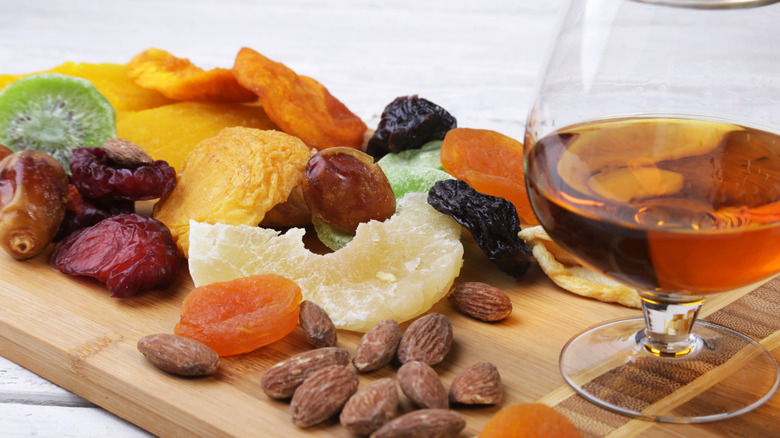 Assorted dried fruits with a glass of whiskey