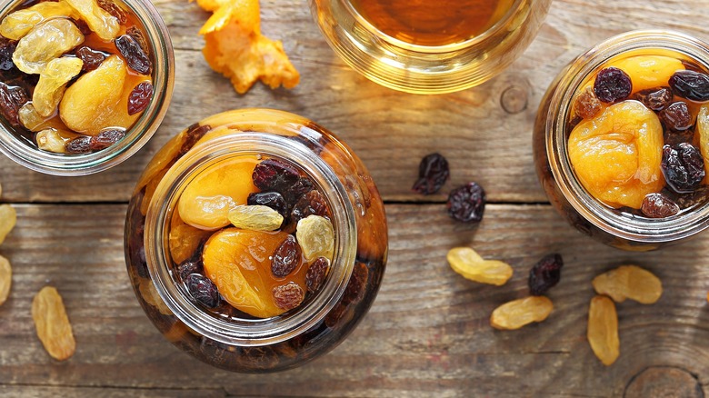 Jars of dried fruits soaking up whiskey