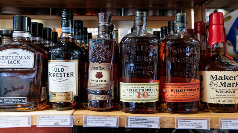A shelf of different bottles of whiskey in a liquor store
