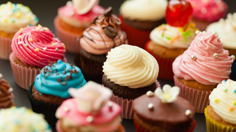 many different color and flavor cupcakes
