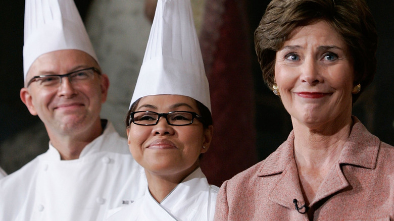 Close-up photo of the faces of Bill Yosses, Cristeta Comerford, and Laura Bush