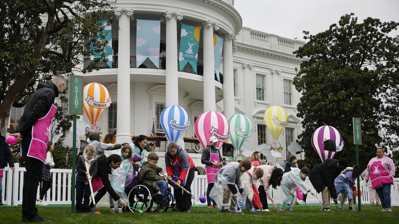 children rolling eggs on the White House lawn at the annual White House egg roll