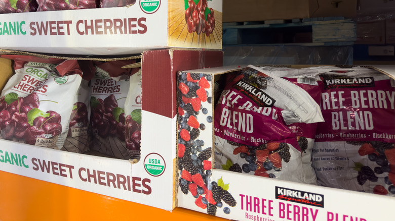 An aisle in Costco with Orangic Sweet Cherries and Kirkland Three Berry Blend