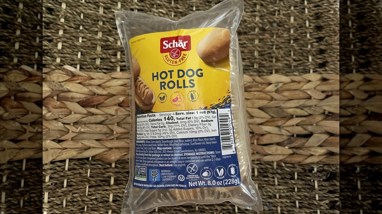 An unopened package of Schar Hot Dog Rolls