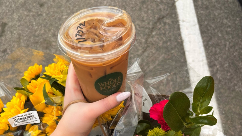Hand holding the new Whole Foods Berry Chantilly Latte