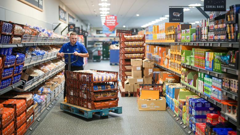 Employee stocking shelves at an Aldi