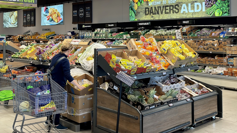 a woman shopping in Aldi's produce section