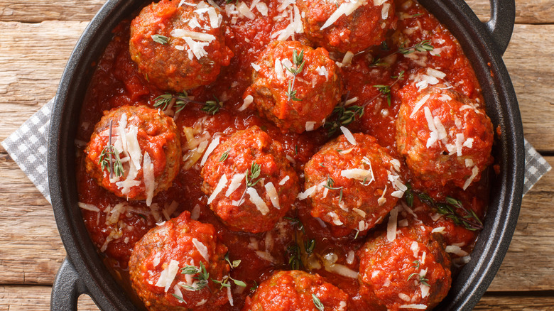 Polpette al sugo in a cast iron pan.