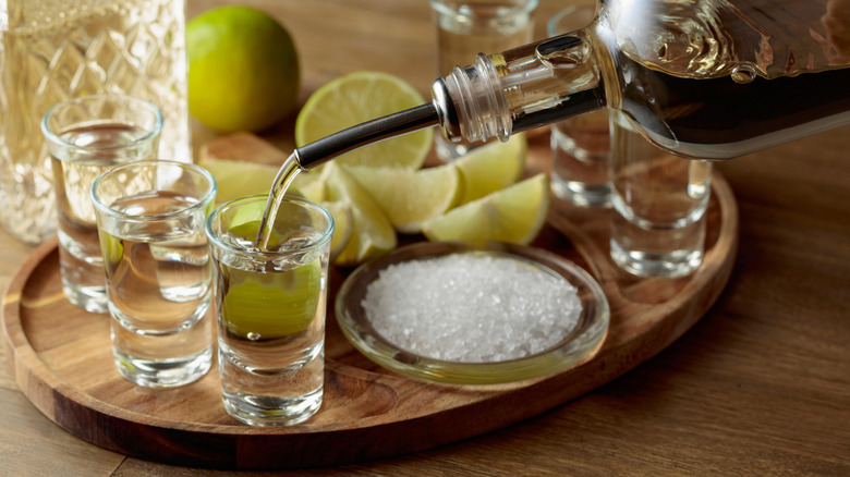 Tequila being poured into a shot glass.