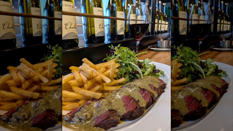 Traditional steak frites with a glass of wine.