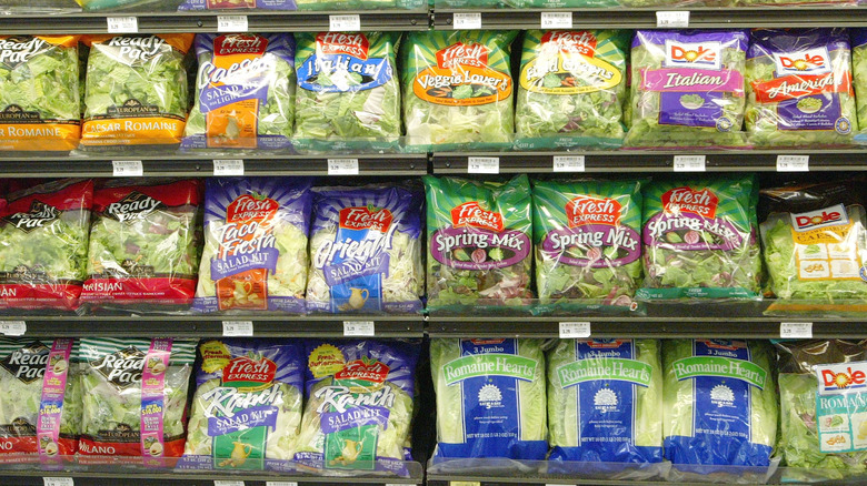 Plastic bags of lettuce at grocery store