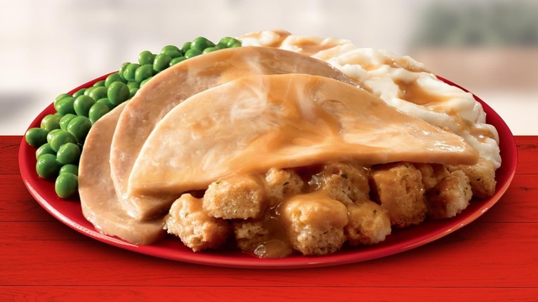 A Banquet turkey meal on red plate