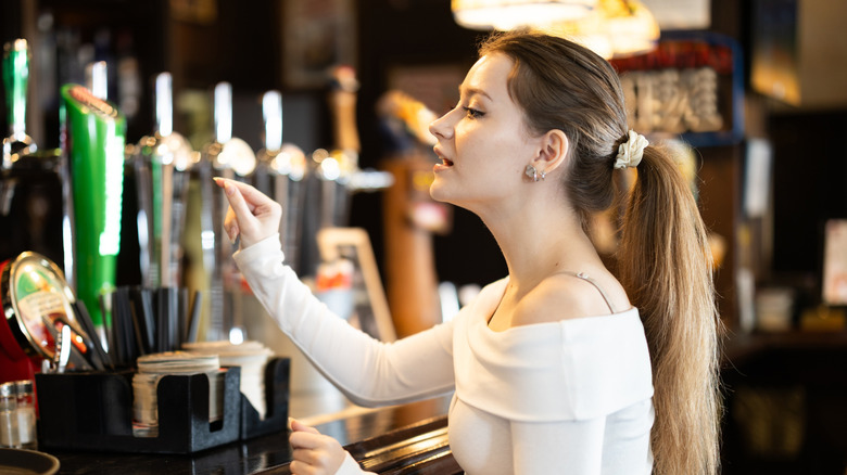 A customer ordering at a bar.