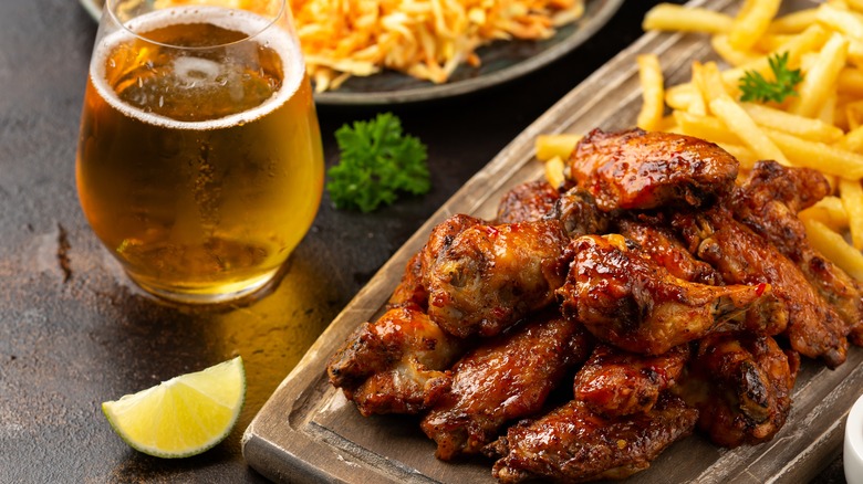 spicy wings and fries with glass of beer