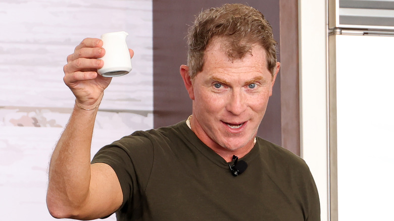 Bobby Flay holding saucer at 2023 South Beach Wine and Food Festival Grand Tasting