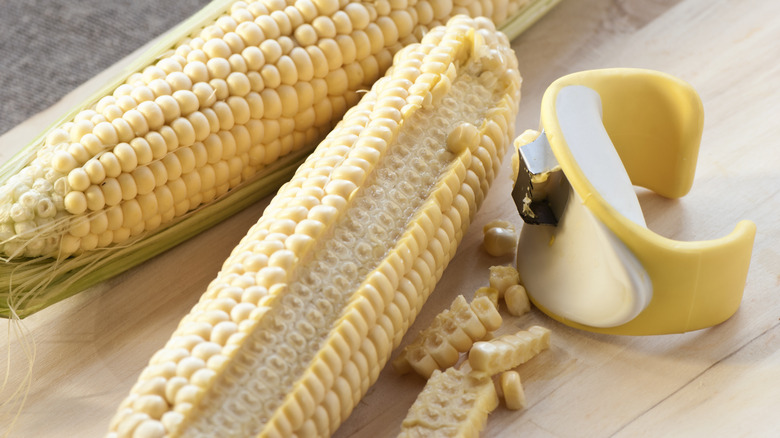 corn cobs next to stripper tool