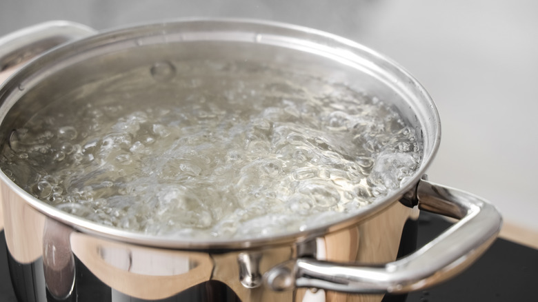 Water is boiling in a stainless steel pot.