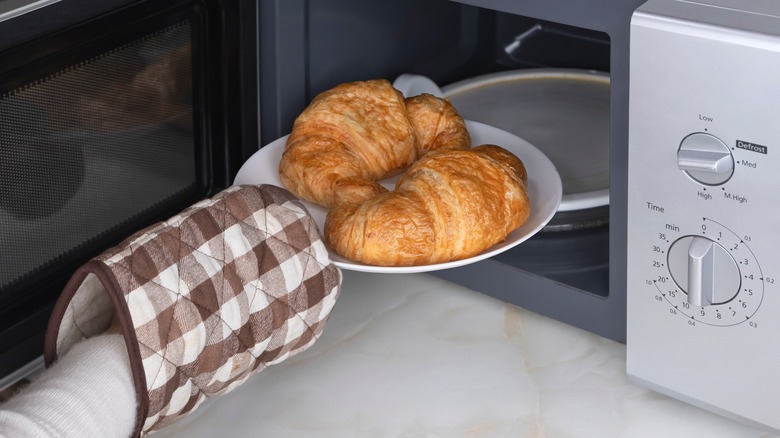 Person microwaving croissants