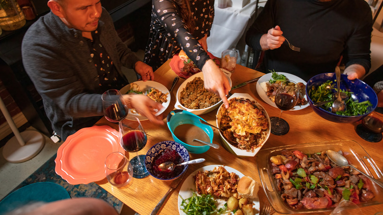 people sharing a potluck dinner