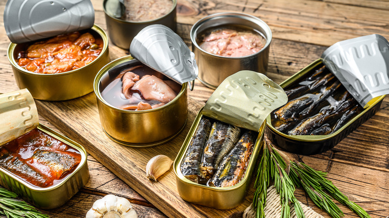 opened cans of various seafood