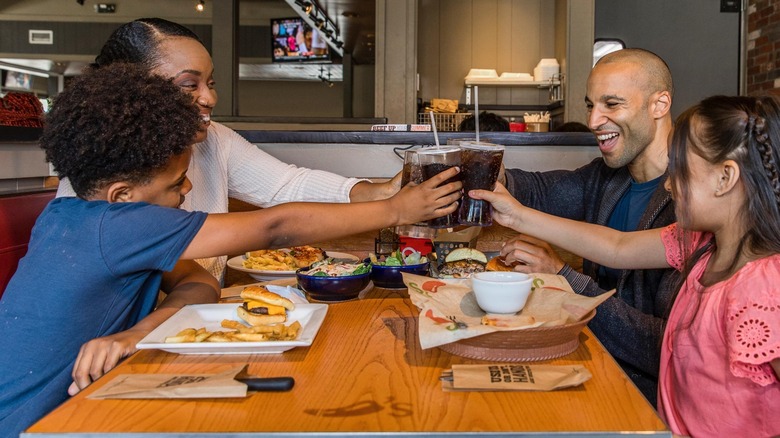 People toasting drinks at a Chili's restaurant