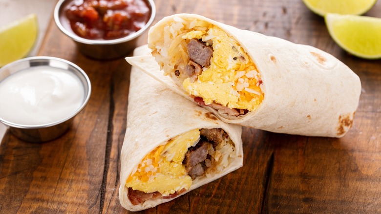 breakfast burrito with side of sour cream and salsa