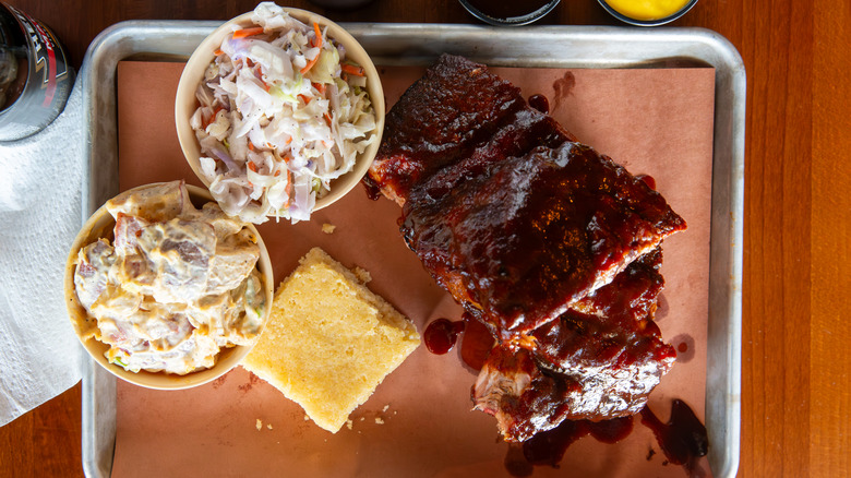 Side of coleslaw pictured on barbecue platter.
