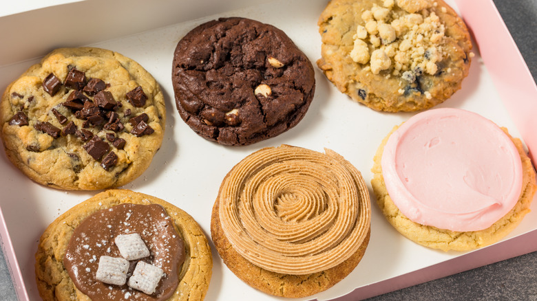 An open box of Crumbl cookies holding six different flavors