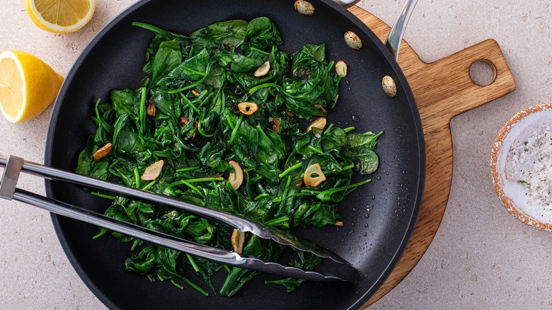 Cooked spinach in pan with garlic